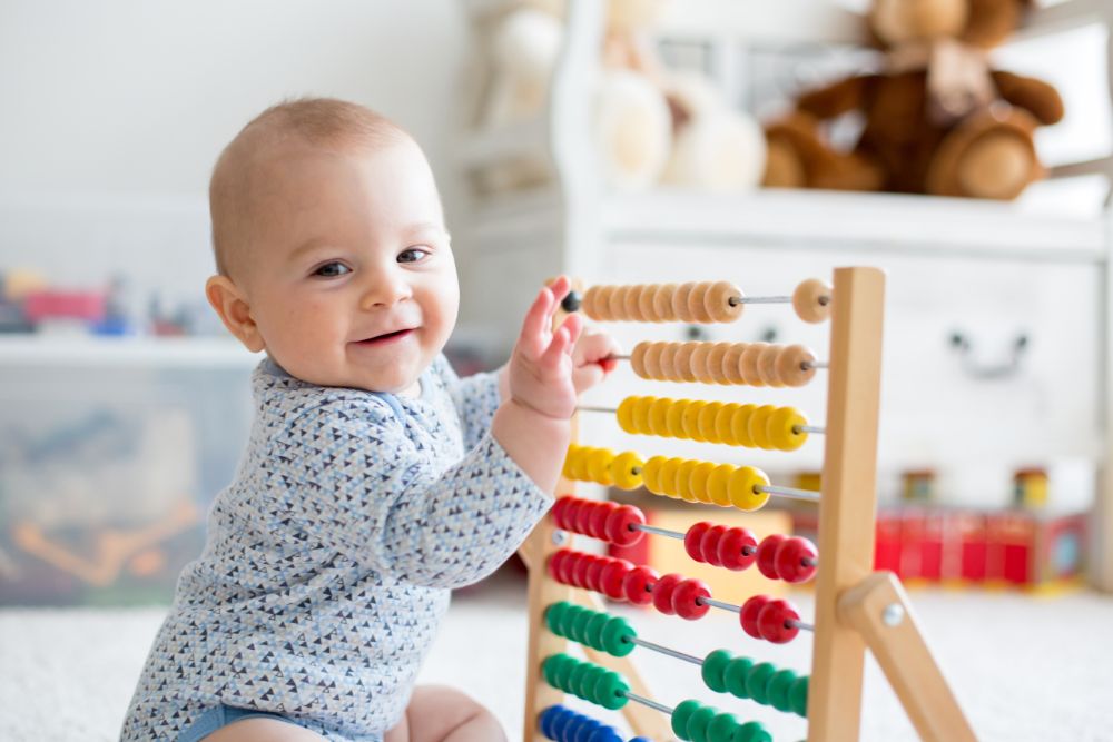 Cute little baby boy, playing with abacus